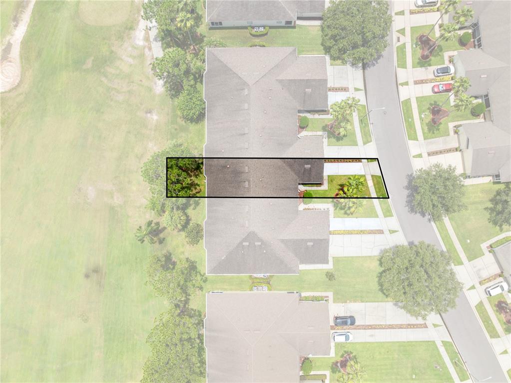 This aerial view shows a residential property highlighted within a black rectangular border — 153 CLUB VILLAS LANE, KISSIMMEE, FL