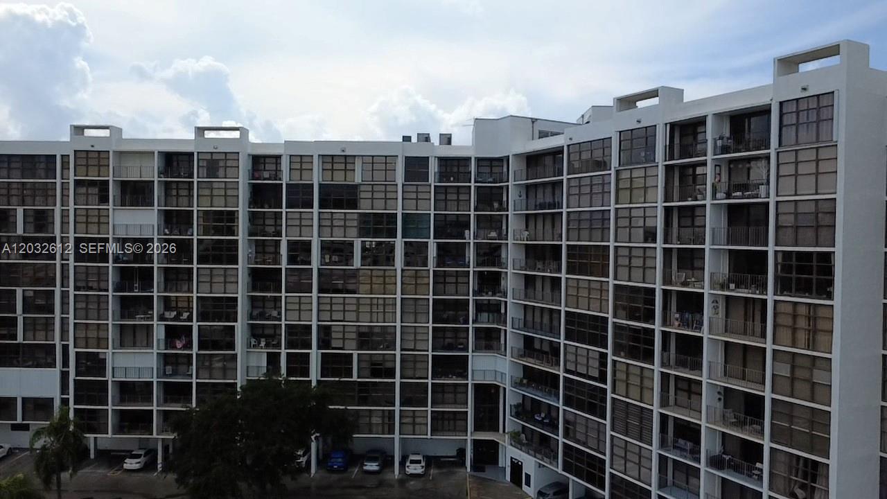 An exterior view of a multi-story residential apartment building with a grid of balconies — 400 Leslie Dr # 1124, Hallandale Beach FL 33009, HALLANDALE BEACH, FL