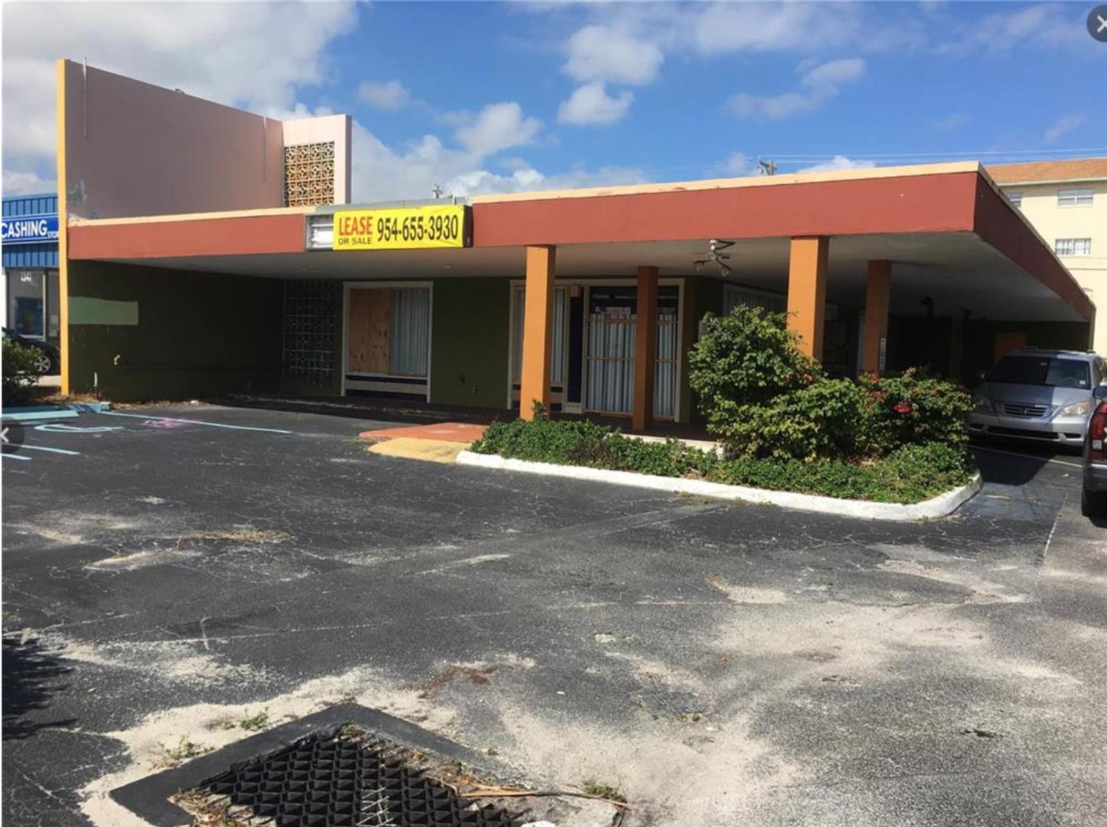 A single-story commercial building with a flat roof, covered walkway, and a parking lot — 1361 E Commercial Boulevard, Oakland Park FL 33334, OAKLAND PARK, FL