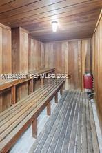 A wood-paneled sauna features tiered bench seating and a wall-mounted heater — 14250 SW 62nd St # 312, Miami FL 33183, MIAMI, FL