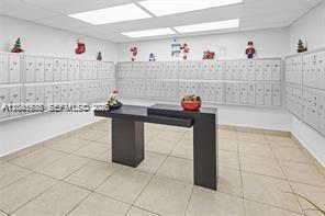 A mailroom features rows of metal mailboxes and a central dark-toned pedestal table — 14250 SW 62nd St # 312, Miami FL 33183, MIAMI, FL