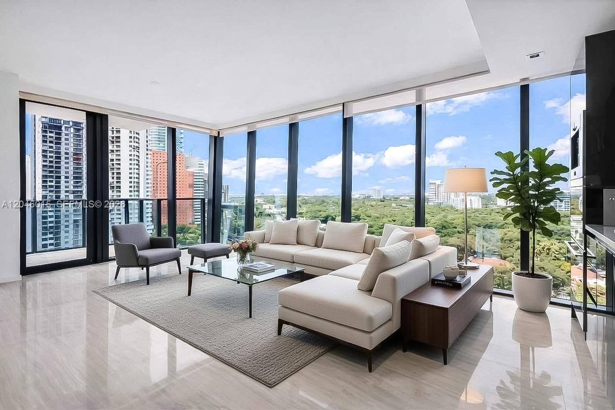 A modern living room features floor-to-ceiling windows, a sectional sofa, and polished tile flooring — 1451 Brickell Ave # 1404, Miami FL 33131, MIAMI, FL