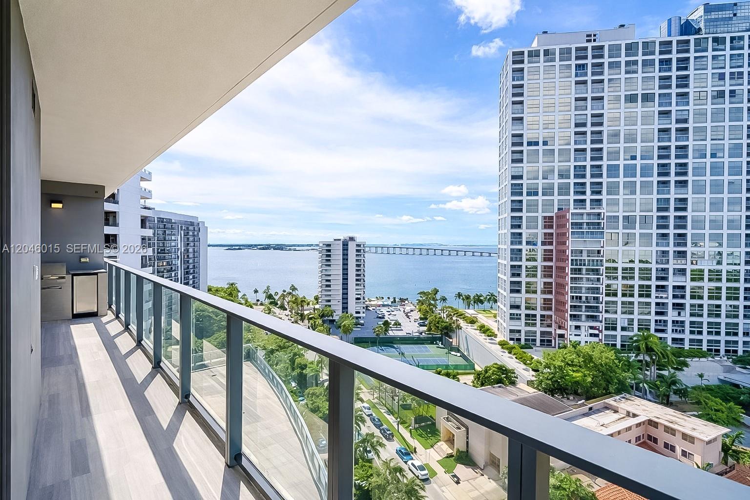 A high-rise balcony features a built-in grill and overlooks a bay with city buildings — 1451 Brickell Ave # 1404, Miami FL 33131, MIAMI, FL