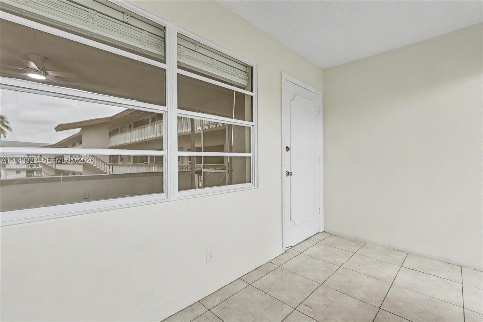 A room with white walls, tiled floors, a window, and a white door — 5300 Washington St # K229, Hollywood FL 33021, HOLLYWOOD, FL