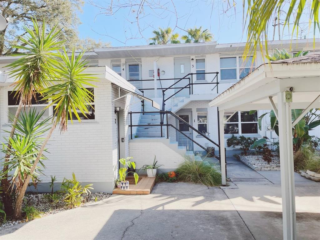 Exterior view of a two-story white brick apartment building with an outdoor staircase — 1070 S CLEARVIEW AVE UNIT 10, TAMPA, FL