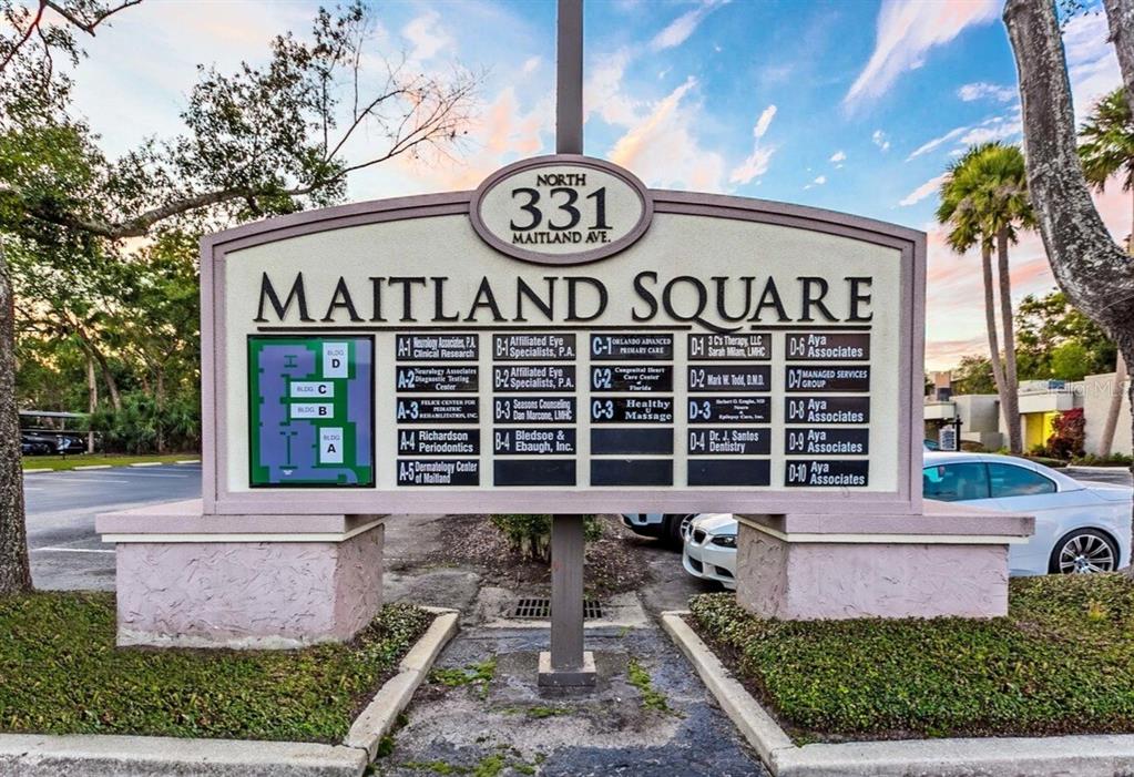A directory sign for Maitland Square stands outdoors in front of a parking lot — 331 N MAITLAND AVE, MAITLAND, FL