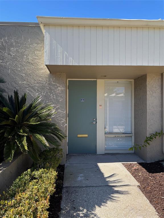 The exterior of a building features a light blue front door and a window with blinds — 331 N MAITLAND AVE, MAITLAND, FL