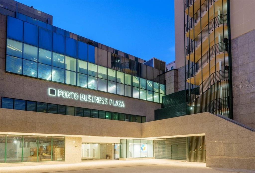 The exterior of the Porto Business Plaza building features a glass facade and stone walls — 290 RUA DE SANTOS POUSADA, PORTO, OC