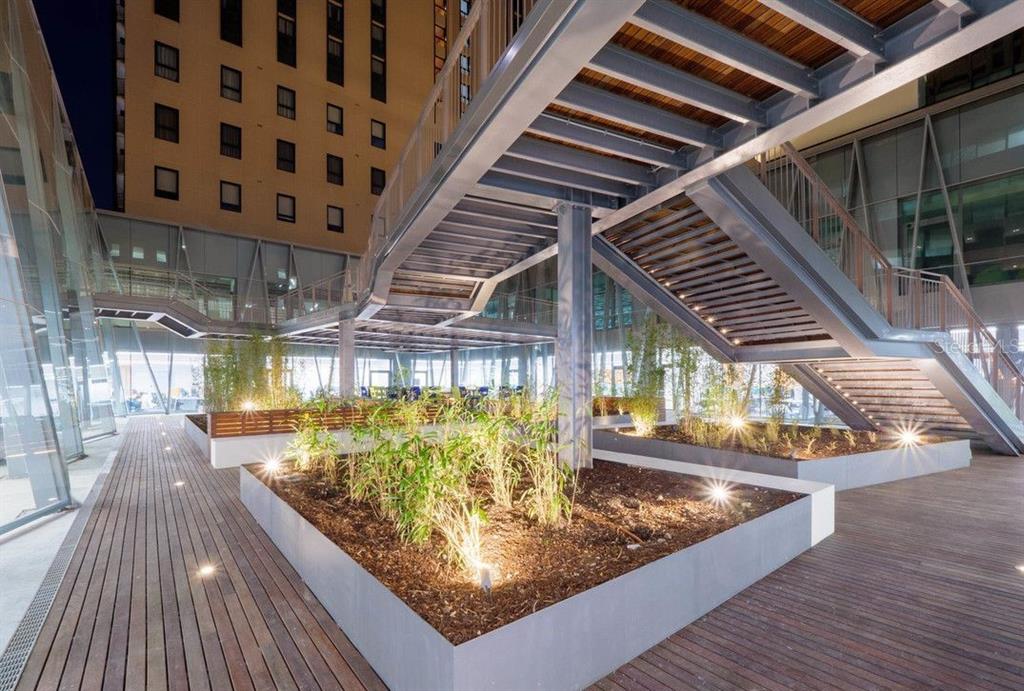 An outdoor terrace features wooden decking, raised garden beds with bamboo, and a metal staircase — 290 RUA DE SANTOS POUSADA, PORTO, OC
