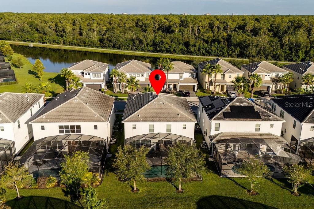 An aerial view shows a row of suburban houses with swimming pools and screened lanais — 2692 CALISTOGA AVENUE, KISSIMMEE, FL