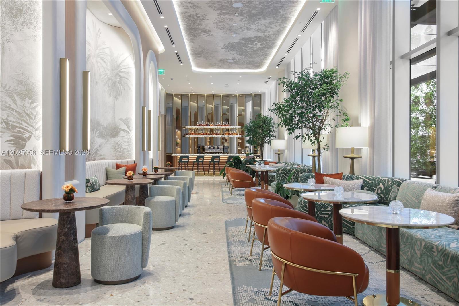 A modern lounge features marble floors, upholstered seating, round tables, and a bar in the back — 77 SE 5th St # 4208, Miami FL 33131, MIAMI, FL