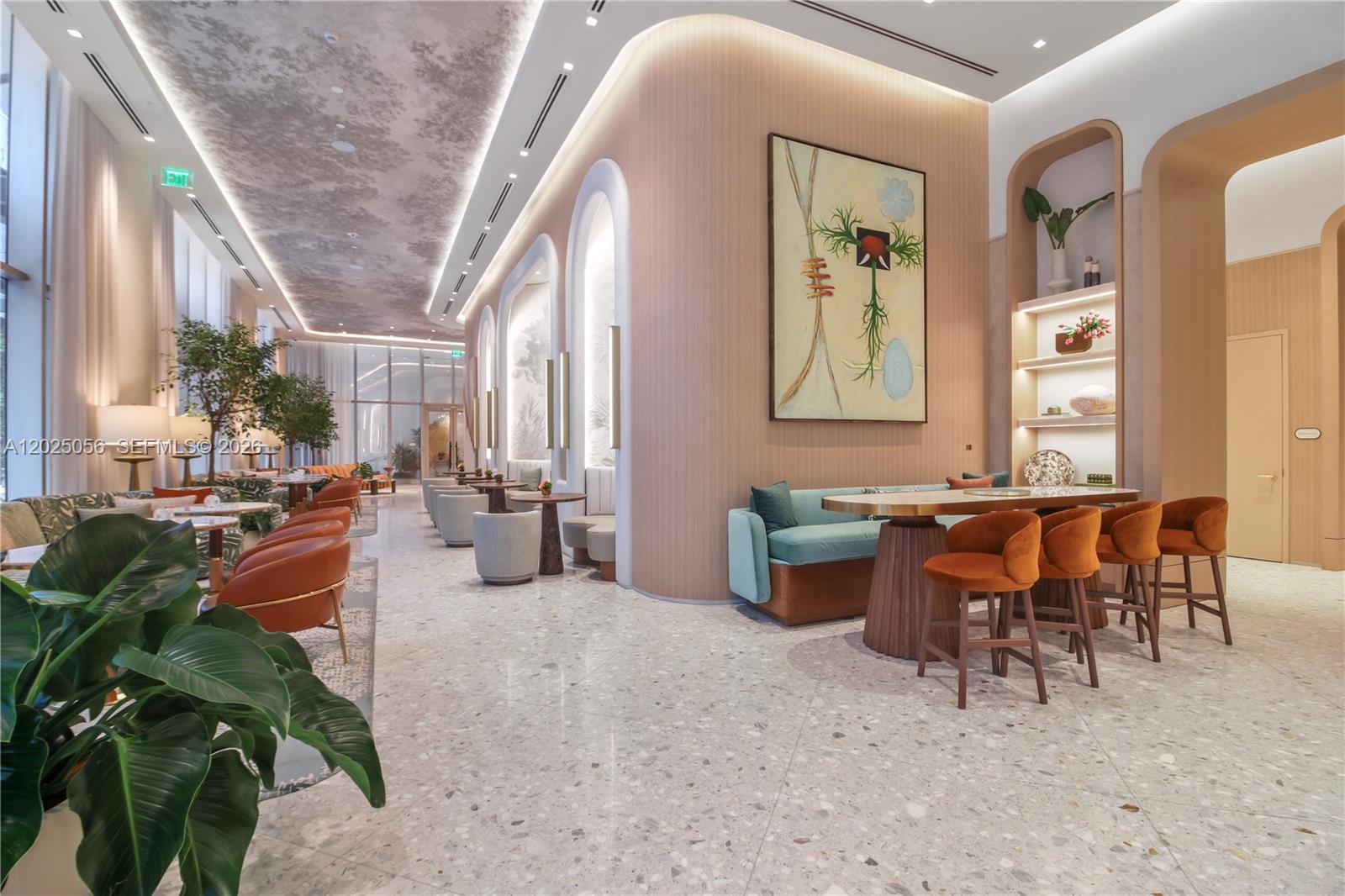 A modern lobby features curved wood-paneled walls, terrazzo flooring, and contemporary lounge seating — 77 SE 5th St # 4208, Miami FL 33131, MIAMI, FL