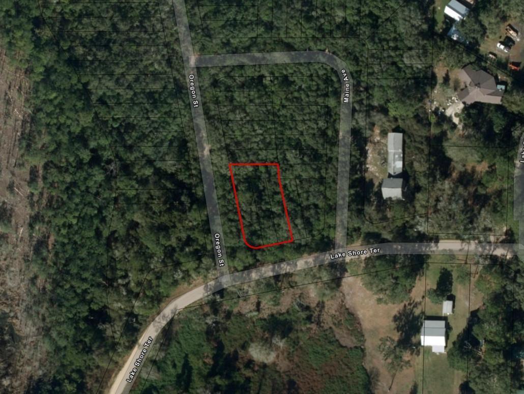 This is an aerial map view showing a vacant, rectangular lot outlined in red — 0 Oregon Street, FL 32148, FL