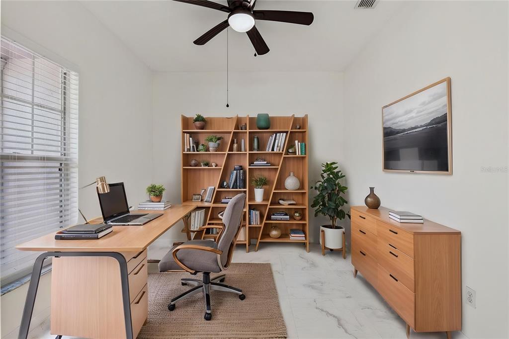 A home office features a wooden desk, bookshelf, dresser, and a ceiling fan — 571 MASALO PLACE, LAKE MARY, FL