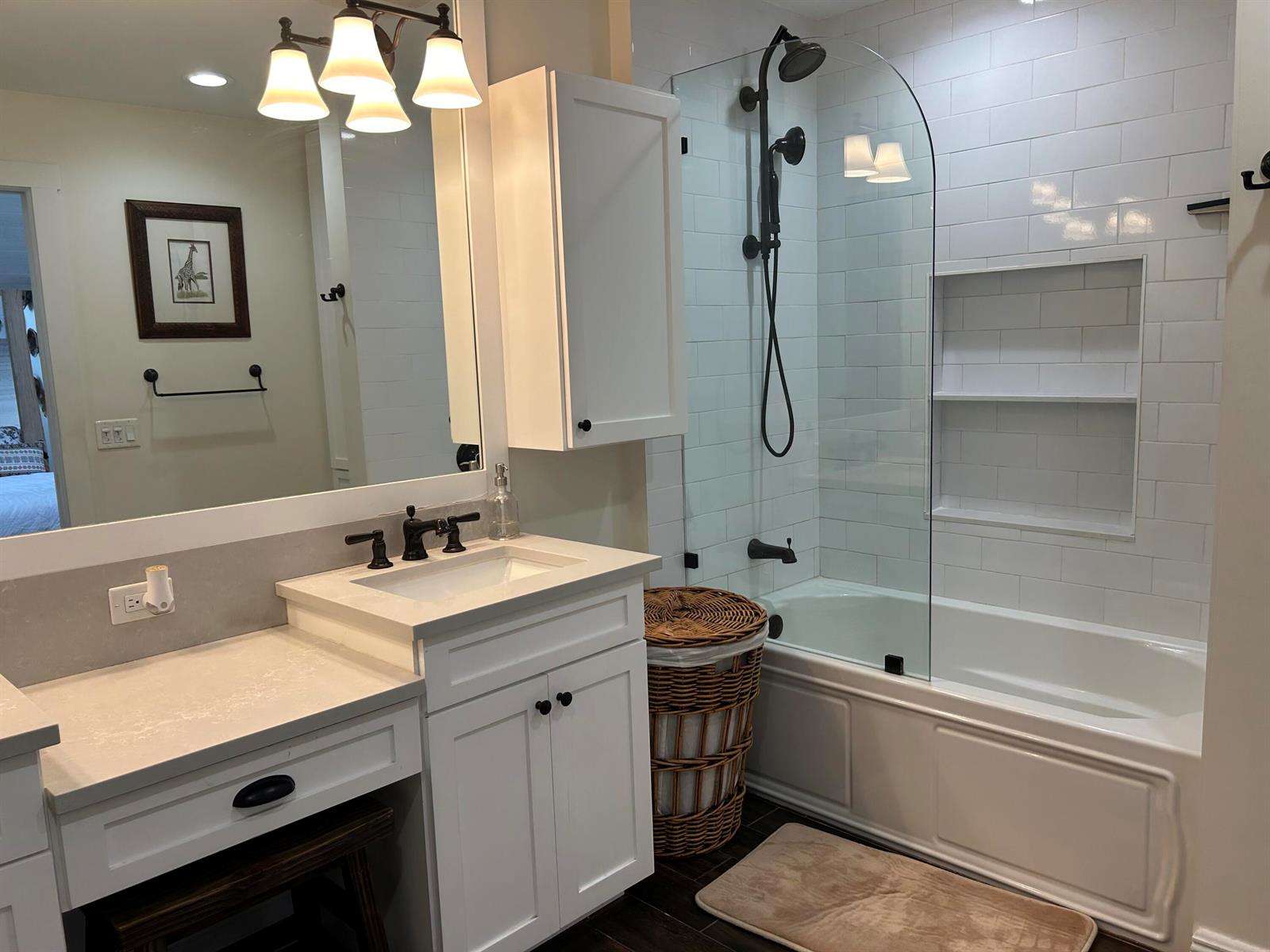 A bathroom features a white vanity, a mirror, and a bathtub with a glass shower panel — 1605 S Us Hwy 1 # H, Jupiter FL 33477, JUPITER, FL