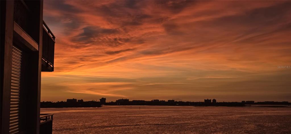 A view of a sunset over a body of water from a building balcony — 6177 SUN BOULEVARD UNIT 401, ST PETERSBURG, FL