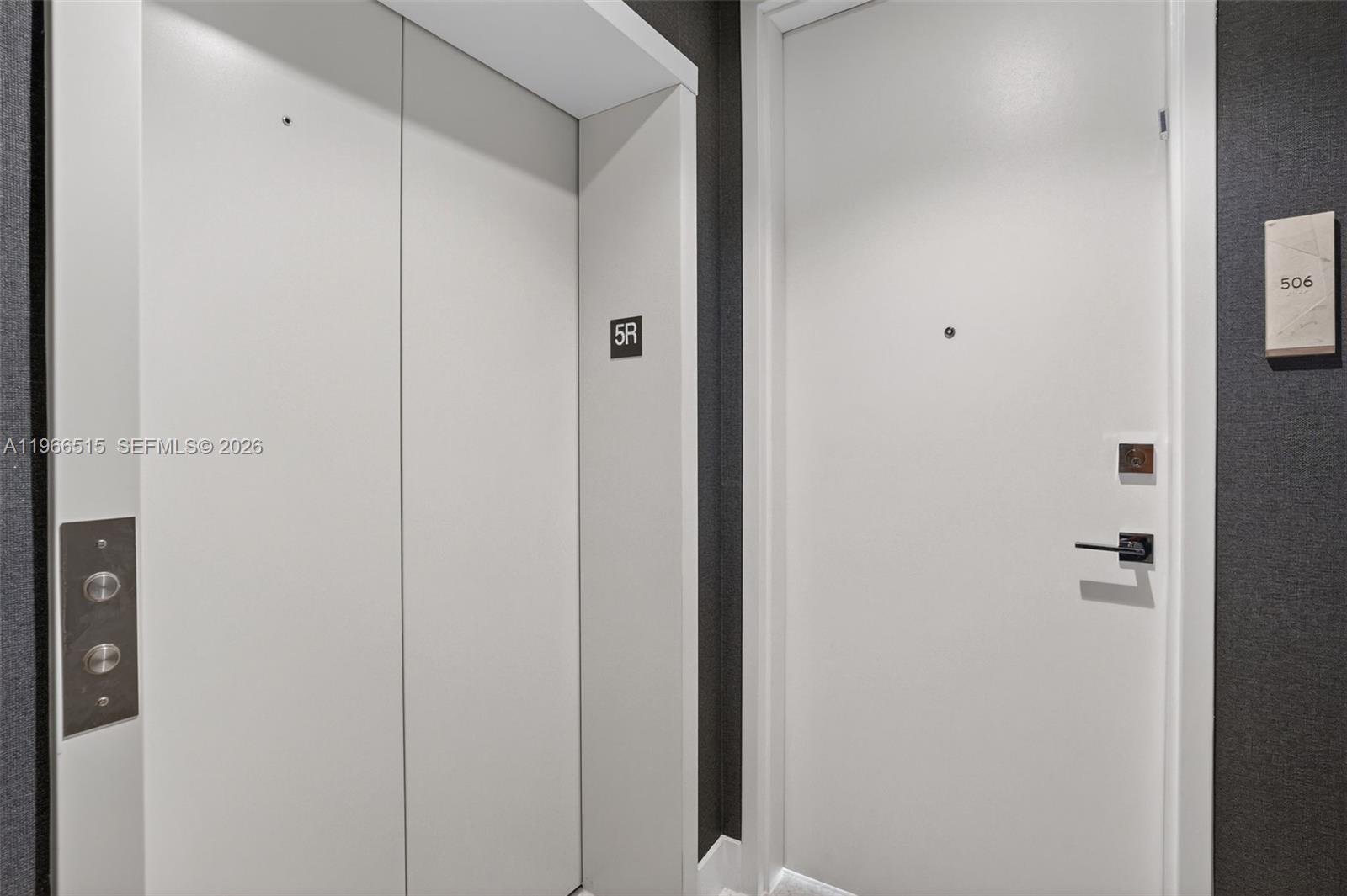 An elevator entrance next to a residential apartment door labeled 506 — 5775 Collins Ave # 506, Miami Beach FL 33140, MIAMI BEACH, FL