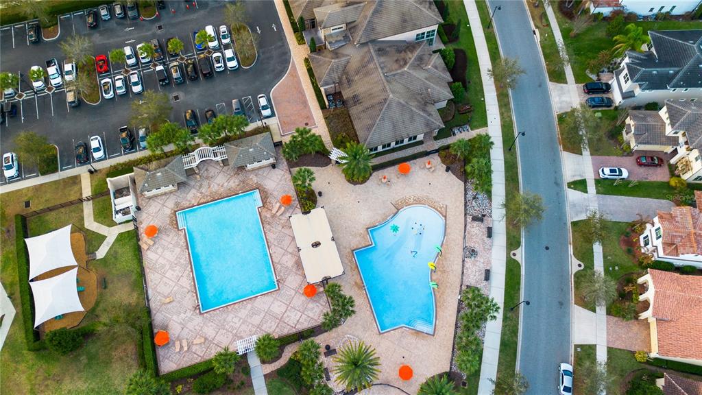 An aerial view shows a community swimming pool area, a parking lot, and nearby houses — 13060 HATHERTON CIRCLE, ORLANDO, FL
