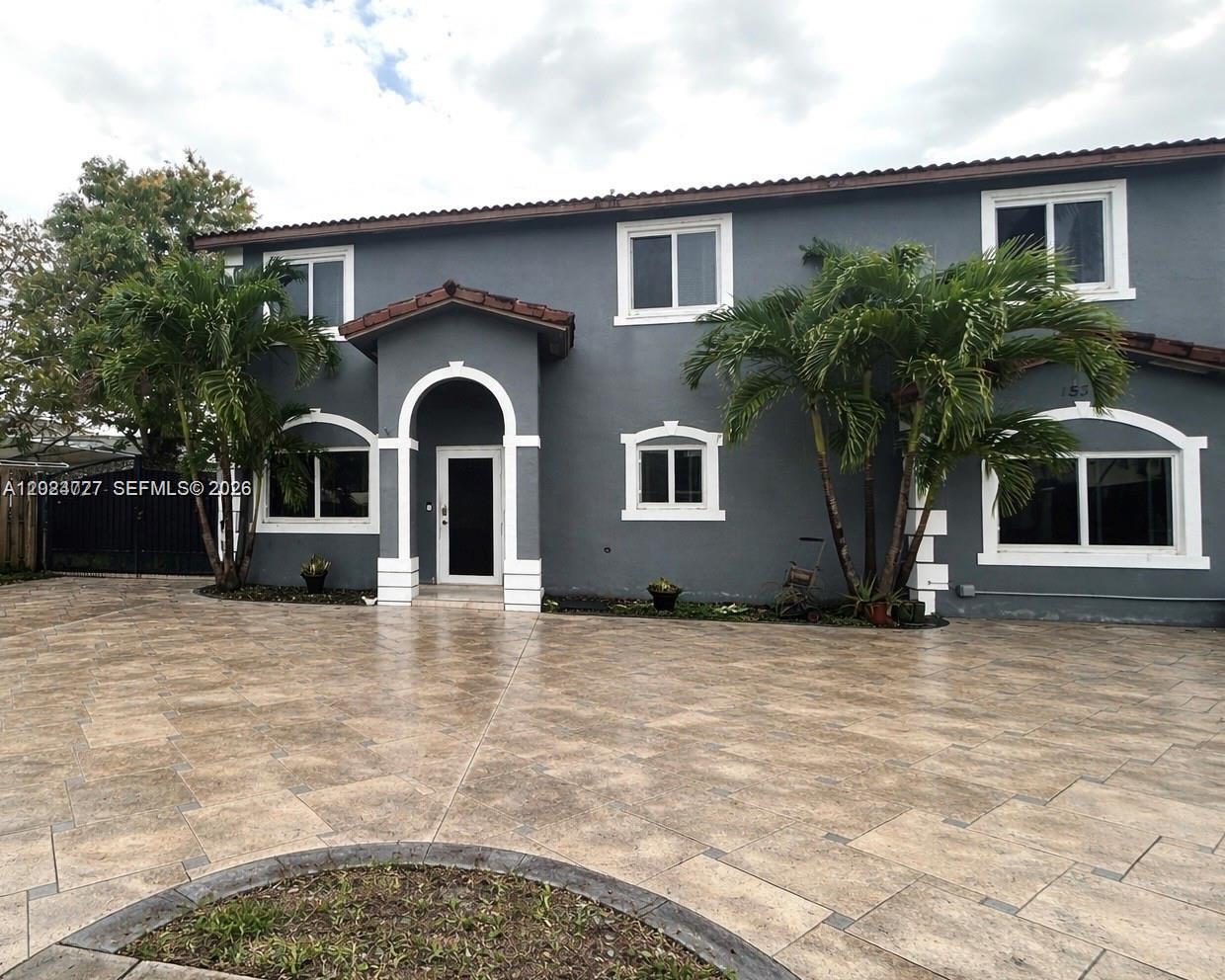 A two-story gray house with a tiled driveway and arched entryway — 15302 SW 180th Ter, Miami FL 33187, MIAMI, FL