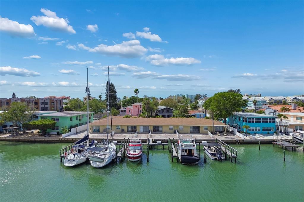 An aerial view shows a waterfront apartment building with several boats docked at the pier — 2307 BAY BOULEVARD, INDIAN ROCKS BEACH, FL