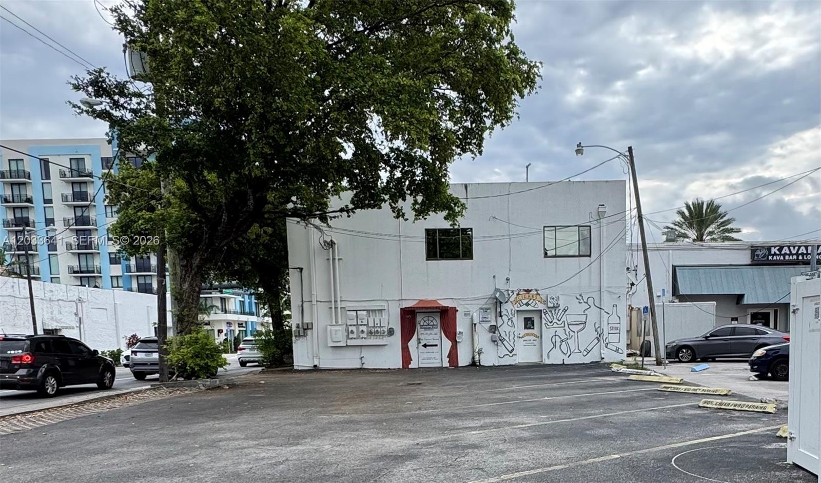 A two-story white commercial building with a parking lot and exterior mural art — 2 S Federal Hwy, Dania Beach FL 33004, DANIA BEACH, FL