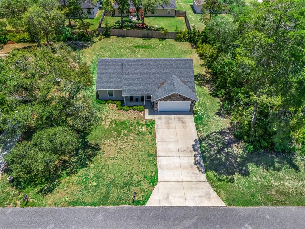 An aerial view shows a single-story house with a concrete driveway and a large yard — 13645 SW 39TH COURT, OCALA, FL
