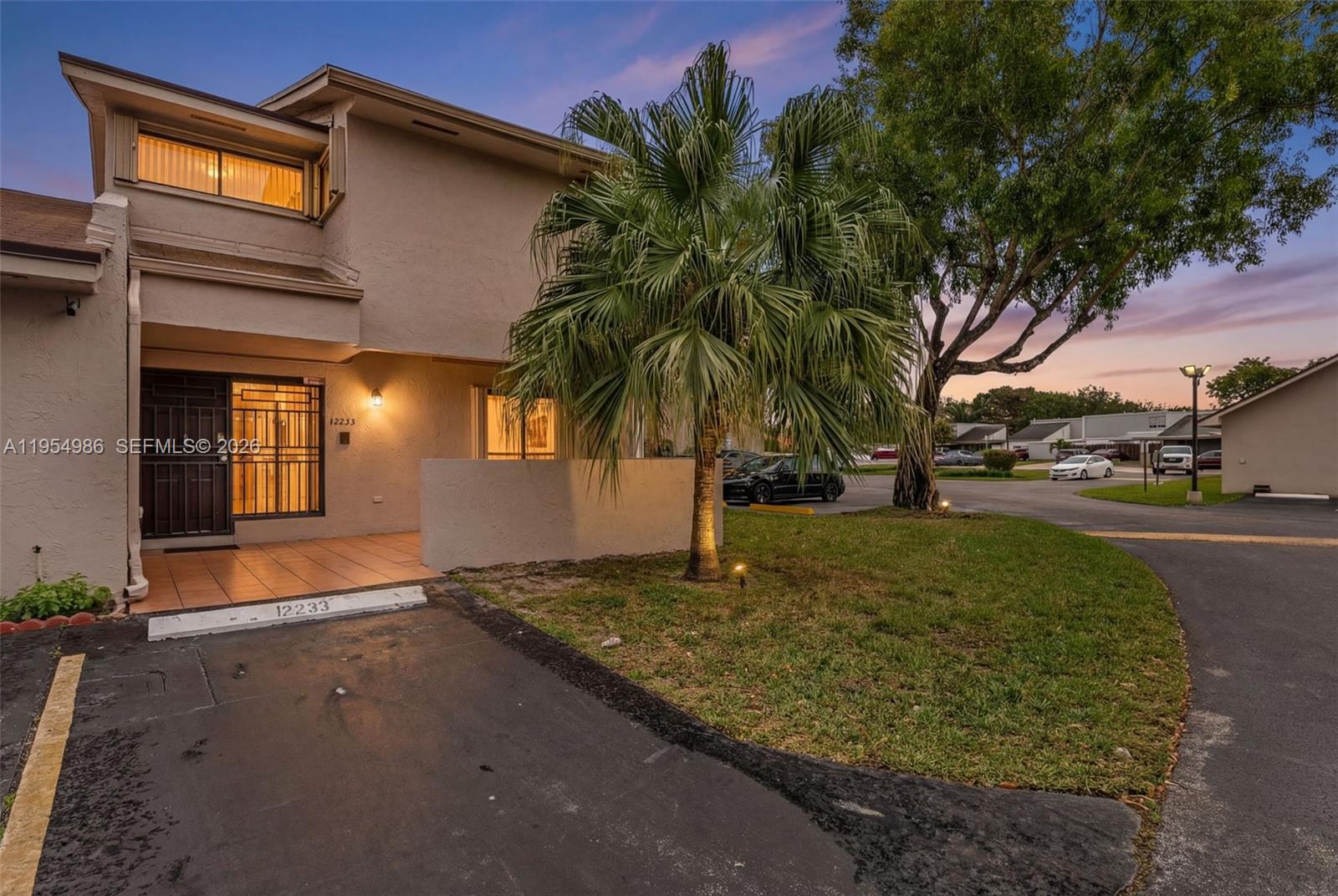 A two-story residential building features a paved driveway, a small palm tree, and an entryway — 12233 SW 24th Ter # 35, Miami FL 33175, MIAMI, FL