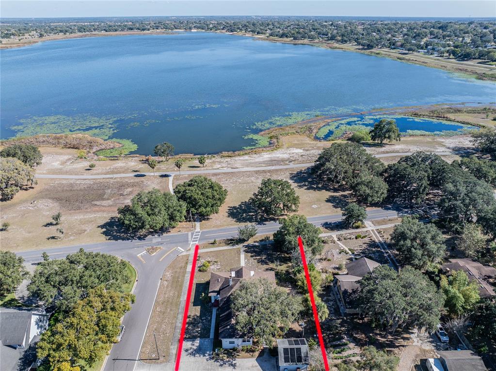 An aerial view shows a house with a red-outlined lot facing a large lake — 102 S LAKESHORE BOULEVARD, LAKE WALES, FL