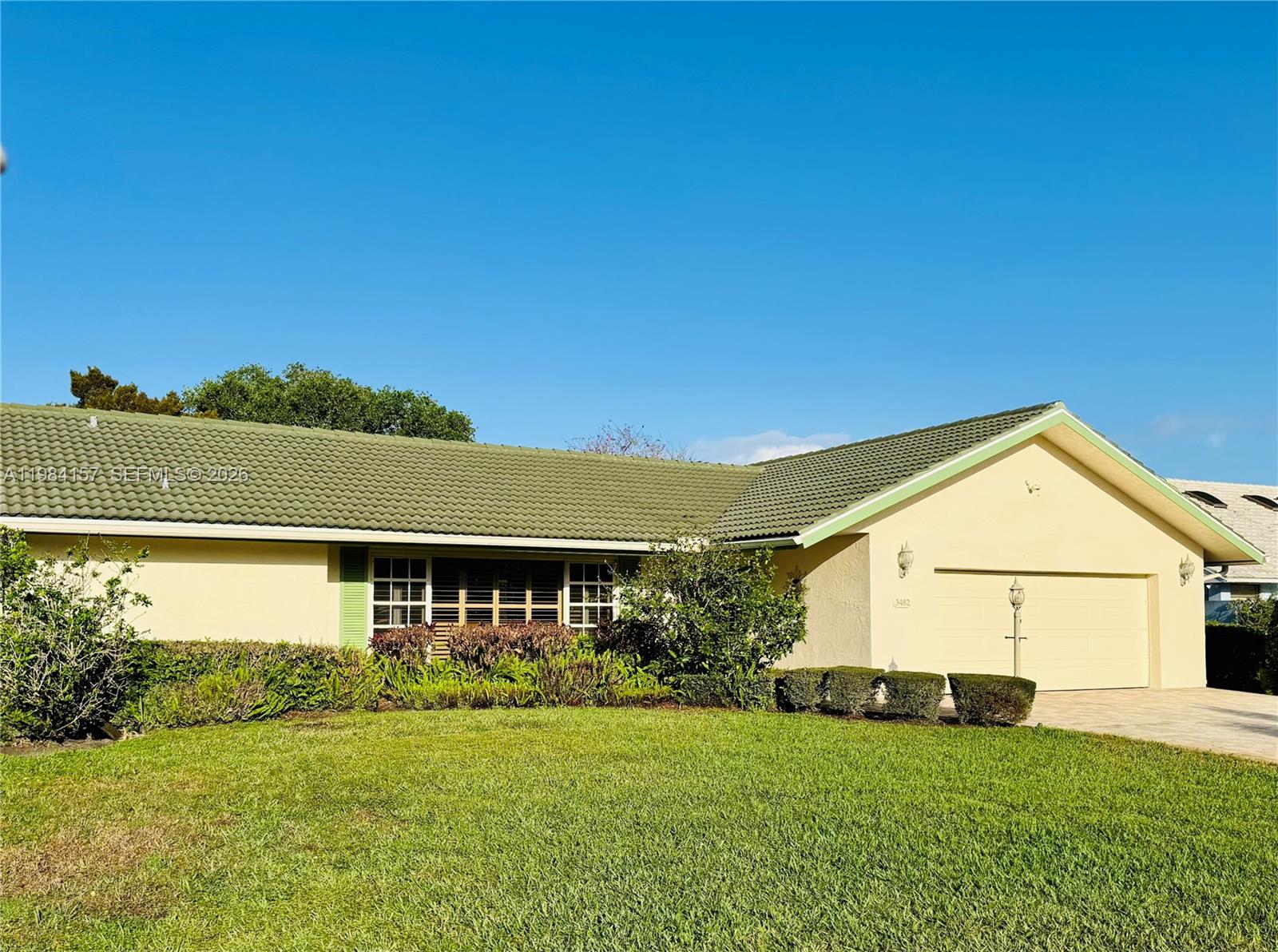 A single-story house with a green tile roof and a two-car garage — 3482 SE Court Dr, Stuart FL 34997, STUART, FL