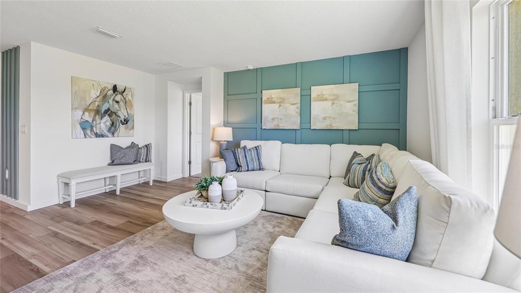 A living room features a white sectional sofa, a round coffee table, and a teal accent wall — 6843 SW 42ND COURT ROAD, OCALA, FL