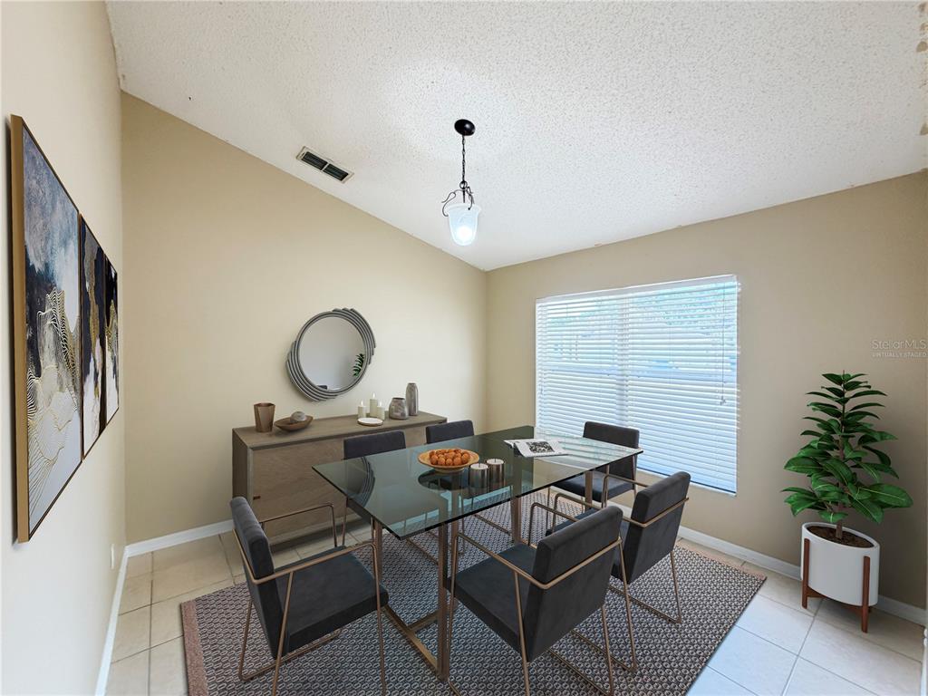 A dining room features a glass-top table, six chairs, a sideboard, and a large window — 1104 STRATTON AVENUE, GROVELAND, FL