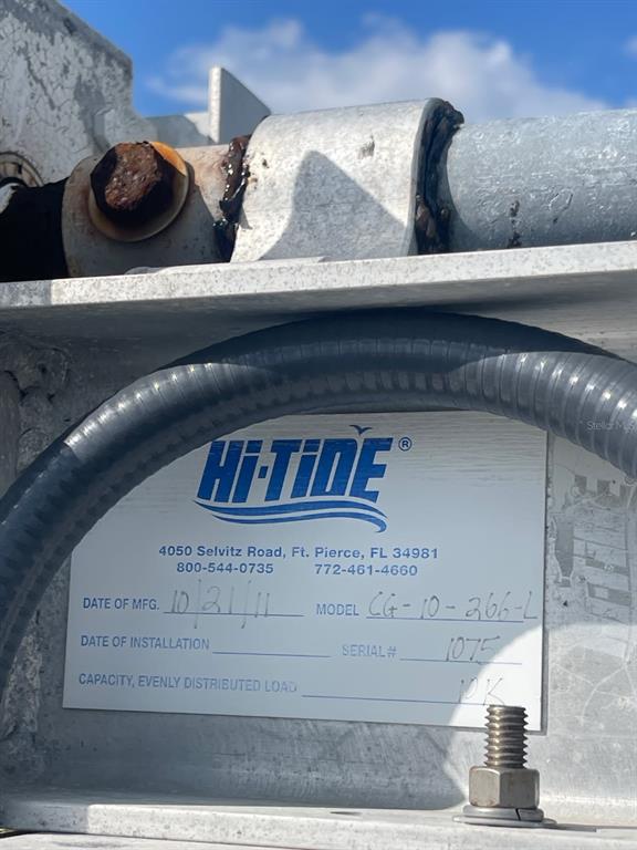 A close-up view of a Hi-Tide boat lift equipment label showing model and serial information — 6020 BOCA GRANDE CAUSEWAY UNIT 43 Boat Slip, BOCA GRANDE, FL