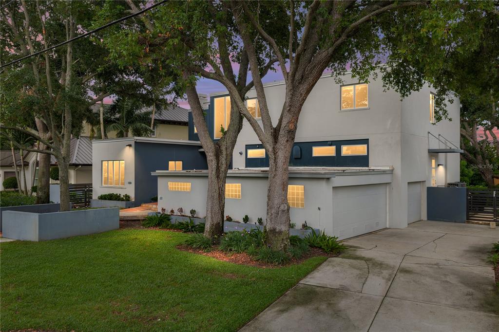 A kitchen features a red island, white cabinetry, stainless steel appliances, and glass sliding doors — 838 MONTEREY BOULEVARD NE, ST PETERSBURG, FL