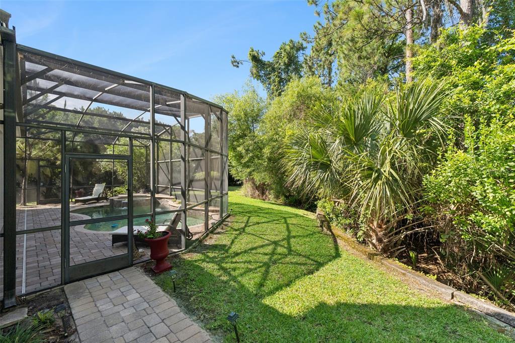 A modern kitchen features white cabinets, stainless steel appliances, and an adjacent dining area — 10370 TROUT ROAD, ORLANDO, FL