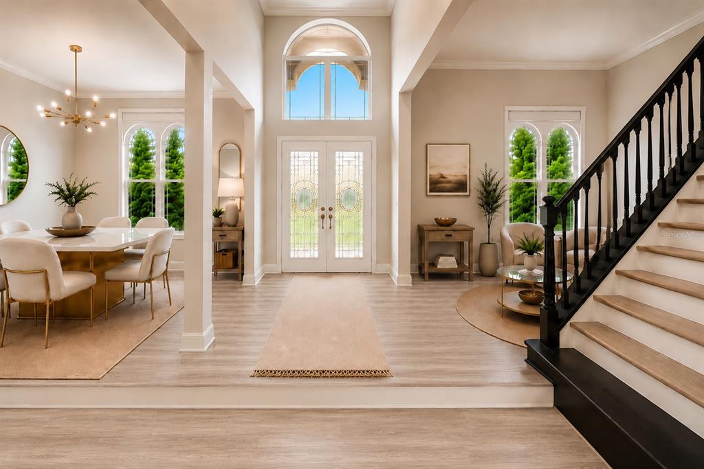 A high-angle view of a living room featuring a fireplace, chandelier, and neutral furniture — 10370 TROUT ROAD, ORLANDO, FL