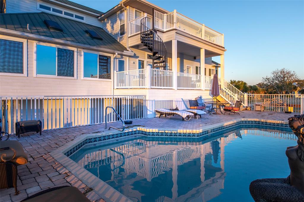 A multi-story house with a spiral staircase, deck, and swimming pool on a brick patio — 2130 NW 14TH STREET, CRYSTAL RIVER, FL