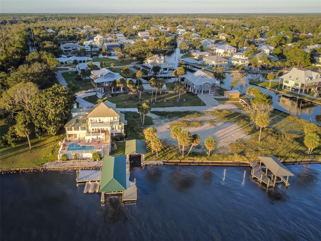 An aerial view shows a waterfront house with a pool, dock, and boat lift — 2130 NW 14TH STREET, CRYSTAL RIVER, FL