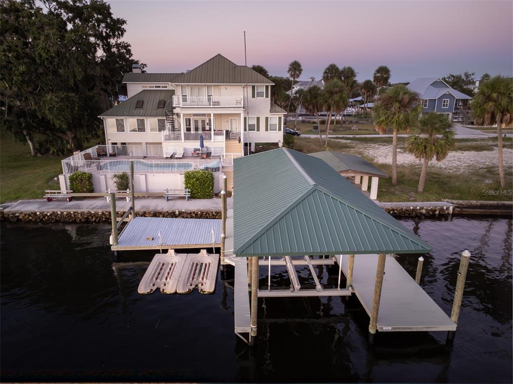 An aerial view of a waterfront house with a pool, dock, and boat lift — 2130 NW 14TH STREET, CRYSTAL RIVER, FL