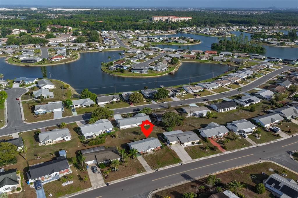An aerial view shows a single-story residential house marked with a red pin — 1216 VALLEY FORGE BOULEVARD, SUN CITY CENTER, FL