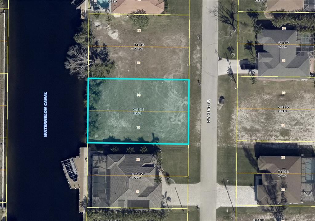 This is an aerial map showing a vacant waterfront lot highlighted in blue — 718 NW 38TH PLACE, CAPE CORAL, FL