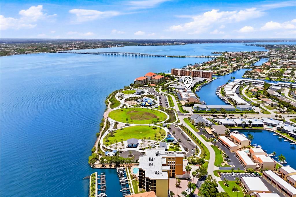 An aerial view shows a waterfront residential complex with a park and a long bridge — 4218 SE 20TH PLACE UNIT D5, CAPE CORAL, FL