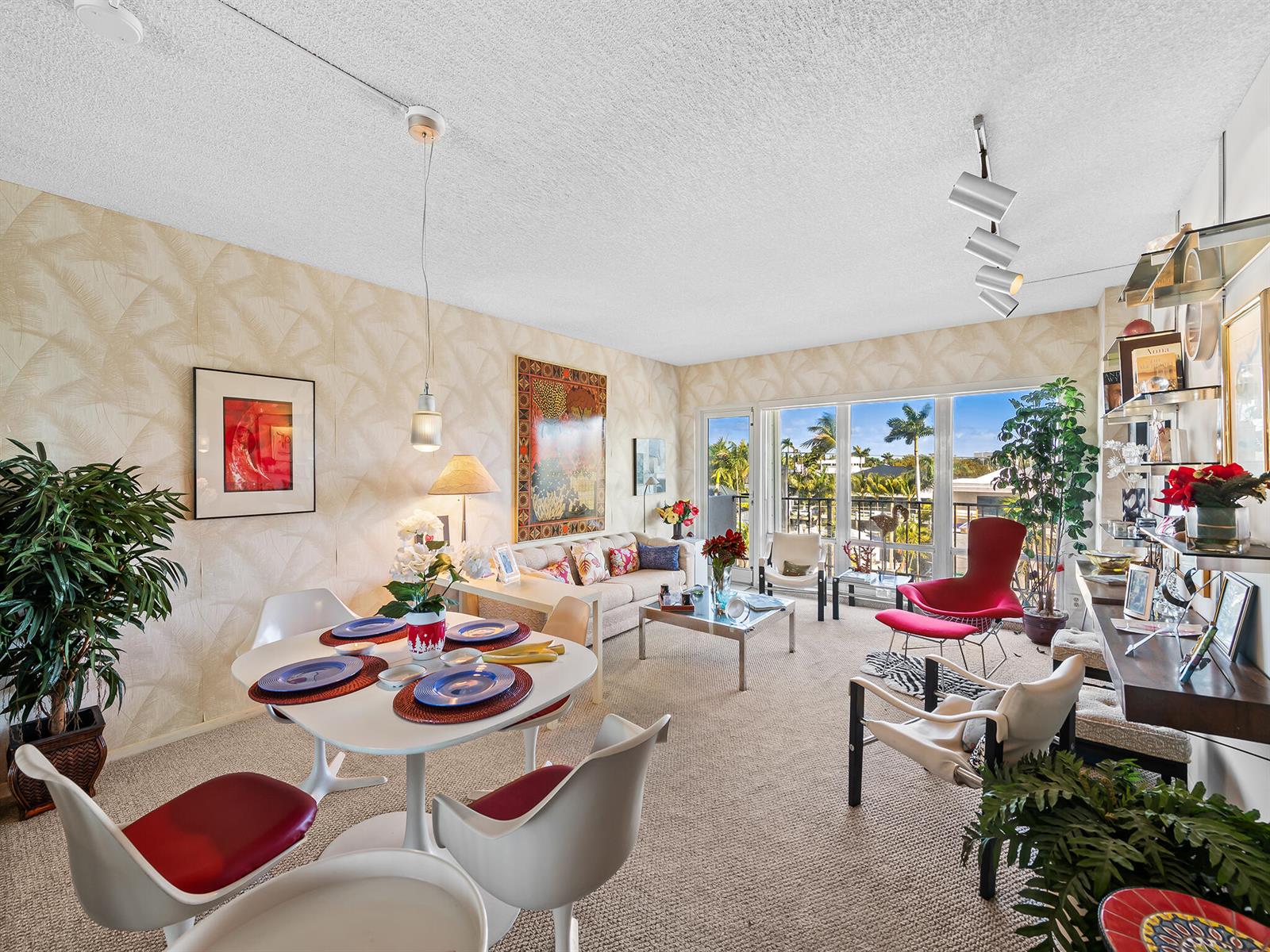 A living and dining area features mid-century modern furniture, patterned wallpaper, and floor-to-ceiling windows — 2500 E Las Olas Boulevard # 404, Fort Lauderdale FL 33301, FORT LAUDERDALE, FL
