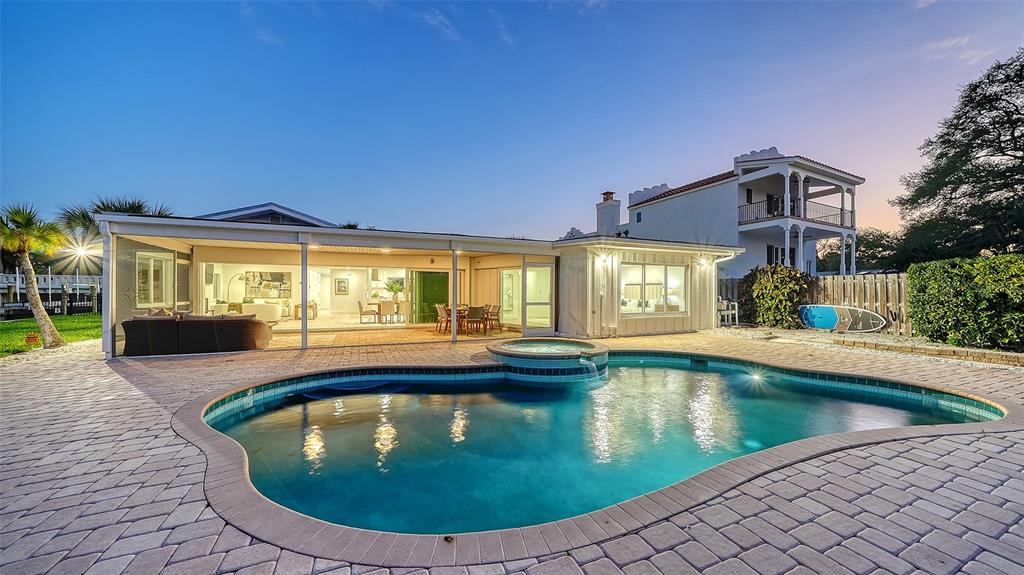 A backyard features a swimming pool with an attached spa and a covered patio area — 339 TREASURE BOAT WAY, SARASOTA, FL