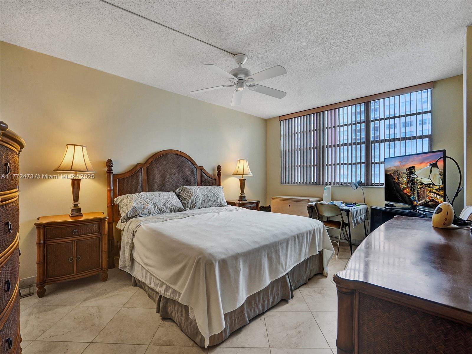 A bedroom features a queen bed, two nightstands, a desk, and a television — 3113 S Ocean Dr # 710, Hallandale Beach FL 33009, HALLANDALE BEACH, FL
