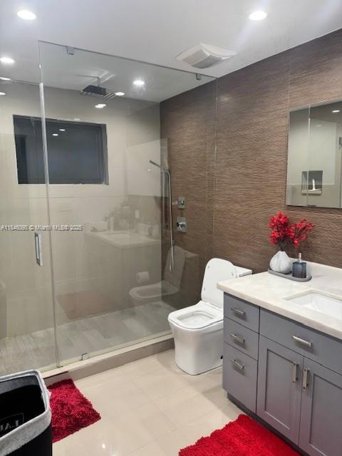 A modern bathroom features a glass-enclosed shower, a white toilet, and a grey vanity cabinet — 4229 W 7th Ln, Hialeah FL 33012, HIALEAH, FL
