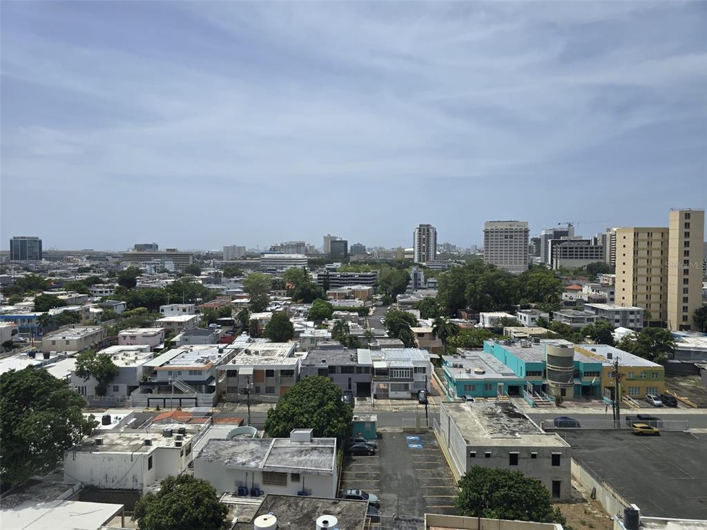 A living room with tile flooring, a ceiling fan, two sofas, and floor-to-ceiling windows — 500 AVE. LUIS MUÑOZ RIVERA UNIT 1003, SAN JUAN, PR