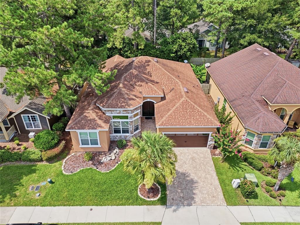 An aerial view shows a single-story house with a brown shingled roof and paved driveway — 14504 NW 25TH AVENUE, NEWBERRY, FL