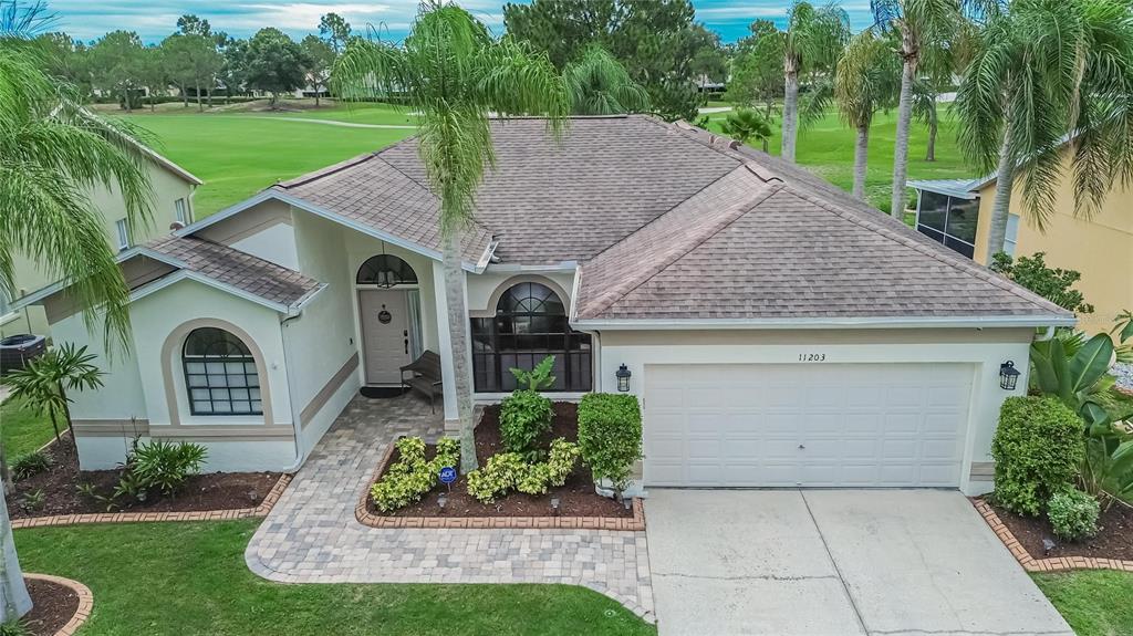 An aerial view of a single-story house with a paved walkway and a two-car garage — 11203 LONGBROOKE DRIVE, RIVERVIEW, FL