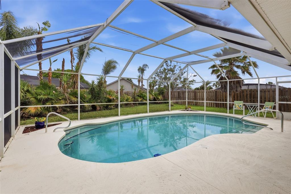 An aerial view of a suburban neighborhood featuring single-family homes with pools and palm trees — 3 SEABRIDGE DRIVE, ORMOND BEACH, FL