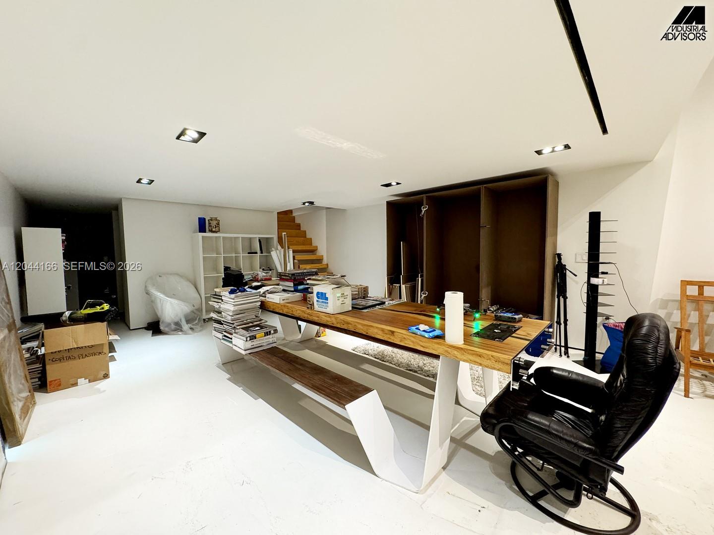 A room features a large wooden table with a bench and a black office chair — 2310 W 79th St, Hialeah FL 33016, HIALEAH, FL